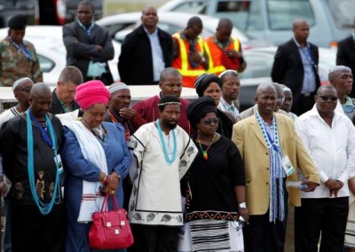 AbaThembu King Buyelekhaya Dalindyebo (3rd L) looks on with some members of his family as former South African President Nelson Mandela's flag-draped coffin arrives at the Mthatha airport, in the Eastern Cape province, 900 km (559 miles) south of Johannesburg for a funeral on Sunday at his ancestral home in Qunu, December 14, 2013. REUTERS/Siphiwe Sibeko