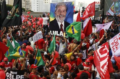 Demonstrators attend a protest in support of Brazil's President Dilma Rousseff and former President Luiz Inacio Lula da Silva, in Sao Paulo, Brazil, Friday, March 18, 2016. Supporters of Silva, who was one of the world's most famous leaders as president from 2003 to 2010, began to gather for rallies in a handful of cities across Brazil, particularly in the industrial south, where the former factory worker has his base. Silva has been tied to a sprawling corruption investigation involving the Brazil oil giant Petrobras. (AP Photo/Andre Penner)