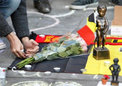 People gather around a memorial featuring a Menneken-Pis statue in Brussels.    REUTERS/Charles Platiau