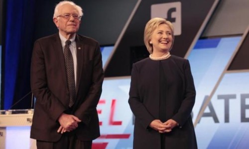 Democratic U.S. presidential candidates Senator Bernie Sanders and Hillary Clinton pose before the start of the Univision News and Washington Post Democratic U.S. presidential candidates debate in Kendall, Florida March 9, 2016. REUTERS/Javier Galeano