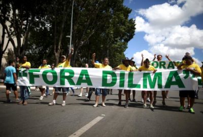 Protesters hold a banner reading "Dilma out", ahead of Brazilian President Dilma Rousseff's impeachment vote, in Brasilia, Brazil April 17, 2016. REUTERS/Adriano Machado