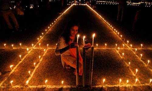 A girl lights candles inside a cricket stadium on the eve of Diwali, the Hindu festival of lights, in Allahabad, India, October 29, 2016. REUTERS/Jitendra Prakash TPX IMAGES OF THE DAY