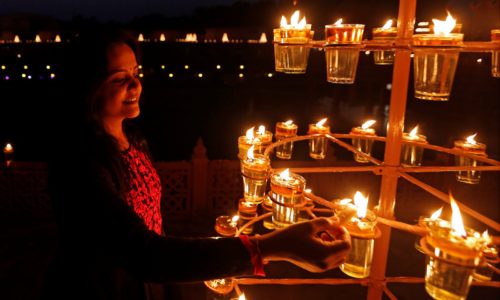 A devotee lights lamps at the Akshardham temple during celebrations on the eve of Diwali, the Hindu festival of lights, in Gandhinagar, India, October 29, 2016. REUTERS/Amit Dave